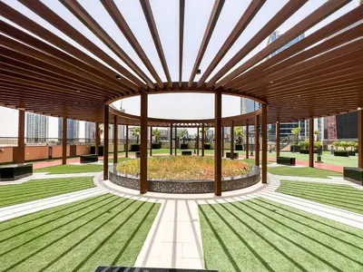 a large wooden building with a garden in the middle at Front Burj View - 6min to Dubai Mall - Pool - Gym in Dubai