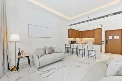 a living room with a couch and a table at Riviera Azure Gateway Superior- 10min to Burj Khalifa, Dubai Mall and Airport and 20min to Marina in Dubai