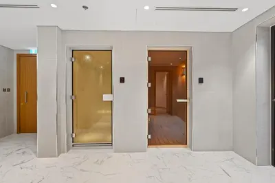 an empty room with two doors and a hallway at Riviera Azure Gateway Superior- 10min to Burj Khalifa, Dubai Mall and Airport and 20min to Marina in Dubai
