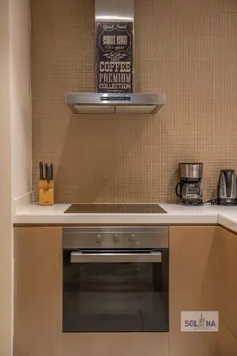a kitchen with a stove and a sign on the wall at Lux One Bedroom at Damac paramount in Dubai