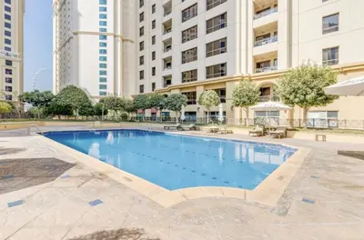 a large swimming pool in front of a building at JBR - spacious and neat 3br apt in Shams 1 in Dubai