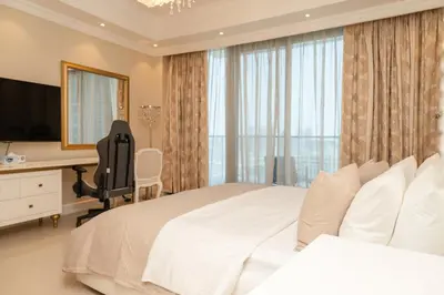 a bedroom with a bed and a desk and a television at BEACH FRONT I 2 Bedroom in TRIDENT JBR Dubai Marina I Palm & Sea Views I Amazing Balcony in Dubai