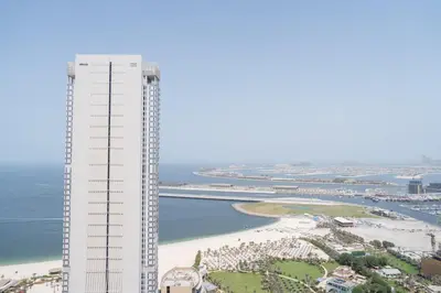 an aerial view of a building and a beach at BEACH FRONT I 2 Bedroom in TRIDENT JBR Dubai Marina I Palm & Sea Views I Amazing Balcony in Dubai