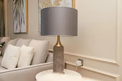 a lamp on a table in front of a couch at BEACH FRONT I 2 Bedroom in TRIDENT JBR Dubai Marina I Palm & Sea Views I Amazing Balcony in Dubai