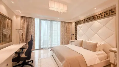a bedroom with a bed and a desk and a window at BEACH FRONT I 2 Bedroom in TRIDENT JBR Dubai Marina I Palm & Sea Views I Amazing Balcony in Dubai