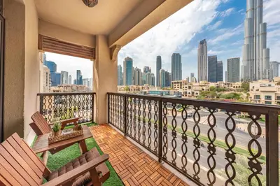 a balcony with two chairs and a view of the city at Theatre Room - Pool Access - Central 2br Apartment in Dubai
