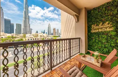 a balcony with a bench and a view of the city at Theatre Room - Pool Access - Central 2br Apartment in Dubai