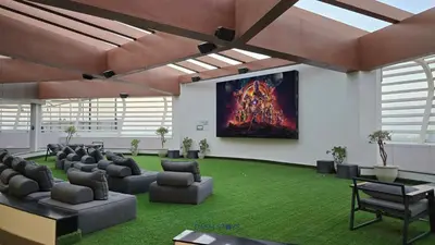 a room with chairs and a large painting on the wall at Luxury 1BR with 2 Balconies Dubai Science Park in Dubai