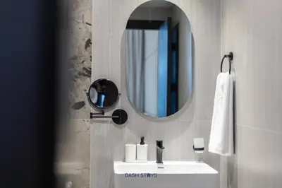 a bathroom with a sink and a mirror at Luxury 1BR with 2 Balconies Dubai Science Park in Dubai