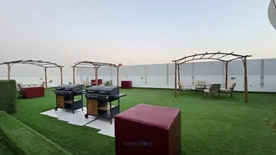 a patio with two ping pong tables and chairs at Luxury 1BR with 2 Balconies Dubai Science Park in Dubai
