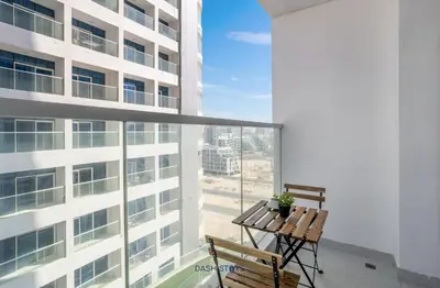 a balcony with a table and chairs on a building at Luxury 1BR with 2 Balconies Dubai Science Park in Dubai