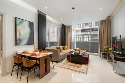 a living room with a couch and a table at Luxury 2 Bedroom Apartment DAMAC Uppercrest Downtown Near Dubai Mall in Dubai