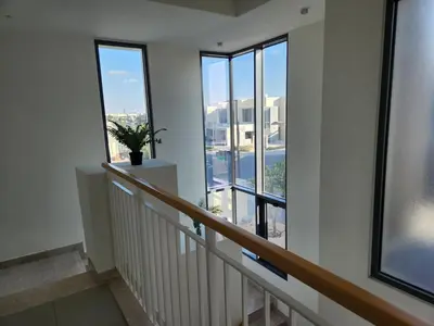 a room with a staircase with windows and a plant at 5 bedroom Villa in Maple 2 Dubai Hills Estate in Dubai