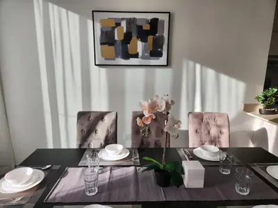 a dining room with a table and two chairs at 5 bedroom Villa in Maple 2 Dubai Hills Estate in Dubai