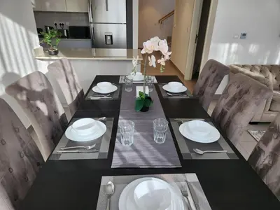 a dining room table with a black table and chairs at 5 bedroom Villa in Maple 2 Dubai Hills Estate in Dubai
