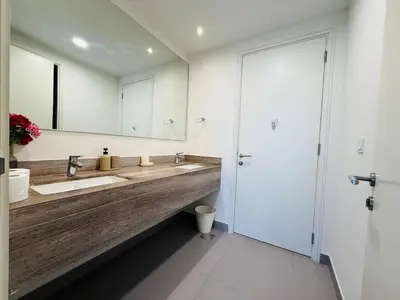 a bathroom with two sinks and a large mirror at 5 bedroom Villa in Maple 2 Dubai Hills Estate in Dubai