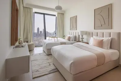 a hotel room with two beds and a couch at Frank Porter - Burj Vista Tower 1 in Dubai