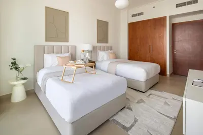 a hotel room with two beds and a table at Frank Porter - Burj Vista Tower 1 in Dubai