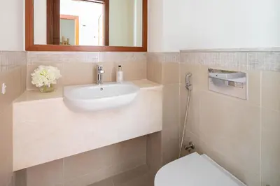 a bathroom with a sink and a toilet at Frank Porter - Burj Vista Tower 1 in Dubai