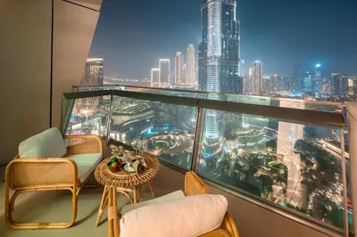 a balcony with chairs and a view of a city at Frank Porter - Burj Vista Tower 1 in Dubai
