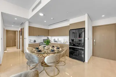 a kitchen and dining room with a table and chairs at Glamarous 2BR Burj Khalifa & Fountain Views in Dubai