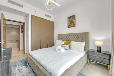 a bedroom with a large bed in a room at Glamarous 2BR Burj Khalifa & Fountain Views in Dubai