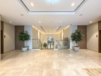an empty lobby with two potted plants in a building at Glamarous 2BR Burj Khalifa & Fountain Views in Dubai