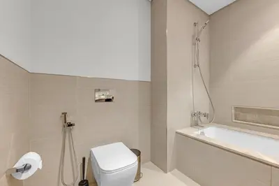 a bathroom with a toilet and a bath tub at Glamarous 2BR Burj Khalifa & Fountain Views in Dubai
