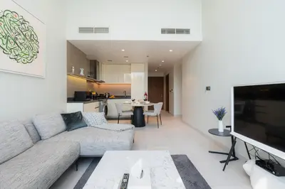 a living room with a couch and a tv at Scenic - Contemporary - Marina Getaway in Dubai