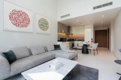 a living room with a couch and a table at Scenic - Contemporary - Marina Getaway in Dubai