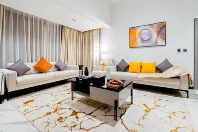 a living room with two couches and a coffee table at Luxurious 1BR Retreat in MAG City Dubai in Dubai