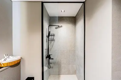 a shower with a glass door in a bathroom at Luxurious 1BR Retreat in MAG City Dubai in Dubai