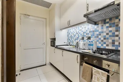 a small kitchen with a sink and a stove at Elegant Studio on Palm Jumeirah With Stunning Views in Dubai