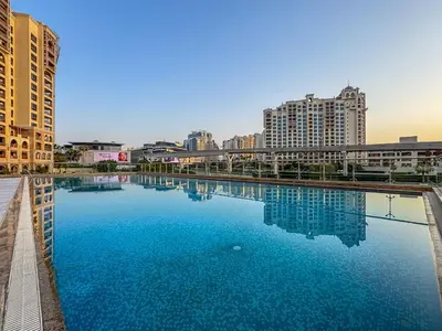 a large pool of blue water in a city at Elegant Studio on Palm Jumeirah With Stunning Views in Dubai