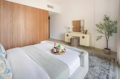 a bedroom with a large white bed and a sink at Frank Porter - Jadeel 3 in Dubai