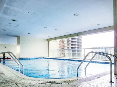 a swimming pool in a building with a large window at Luxury 1BR in Sulafa Tower by EE Holiday Homes in Dubai