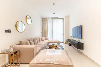 a living room with a couch and a tv at HAVN - New 2 Bedroom in Binghatti Amber, JVC in Dubai