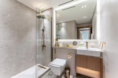 a bathroom with a toilet and a sink and a shower at HAVN - New 2 Bedroom in Binghatti Amber, JVC in Dubai