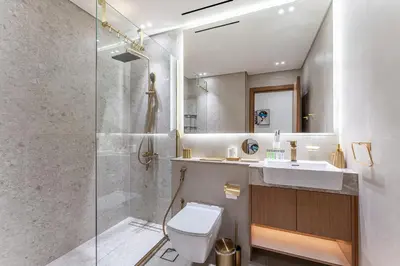 a bathroom with a shower and a toilet and a sink at HAVN - New 2 Bedroom in Binghatti Amber, JVC in Dubai