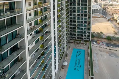 an overhead view of a tall apartment building with a sign at HAVN - New 2 Bedroom in Binghatti Amber, JVC in Dubai