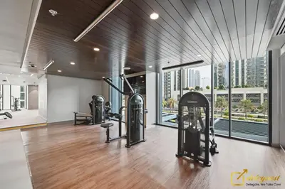 a gym with treadmills and exercise equipment in a building at Premium 1BR with Panoramic Views Creek Harbour Steps from Creek Harbour Walk in Dubai