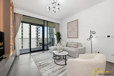 a living room with a couch and a table at Premium 1BR with Panoramic Views Creek Harbour Steps from Creek Harbour Walk in Dubai