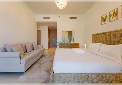 a living room with a large bed and a couch at Aspin 3BR Iconic Burj Khalifa Live Fountain View in Dubai