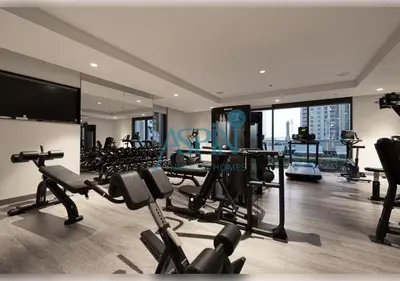 a gym with treadmills and cardio equipment in a building at Aspin 3BR Iconic Burj Khalifa Live Fountain View in Dubai