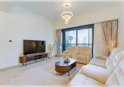 a living room with white furniture and a large tv at Aspin 3BR Iconic Burj Khalifa Live Fountain View in Dubai