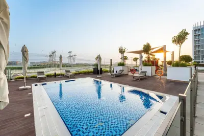 a swimming pool on the roof of a building at Livin' Holidays - Studio - Stylish Stay in Azizi in Dubai