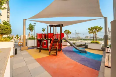 a playground with a slide and a canopy at Livin' Holidays - Studio - Stylish Stay in Azizi in Dubai