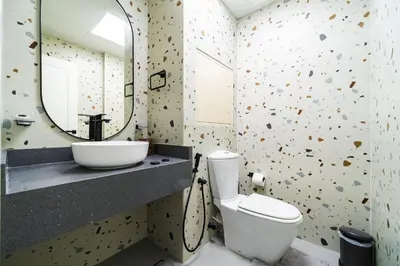 a bathroom with a sink and a toilet and a mirror at SettlerHomes - Stunning JBR 2BR Just 5mins To The Beach in Dubai