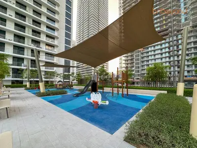 a playground with a slide in a city at Private Beach and Pool Vibes at Palace Residences in Dubai