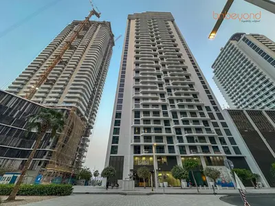 two tall buildings are under construction in a city at Private Beach and Pool Vibes at Palace Residences in Dubai